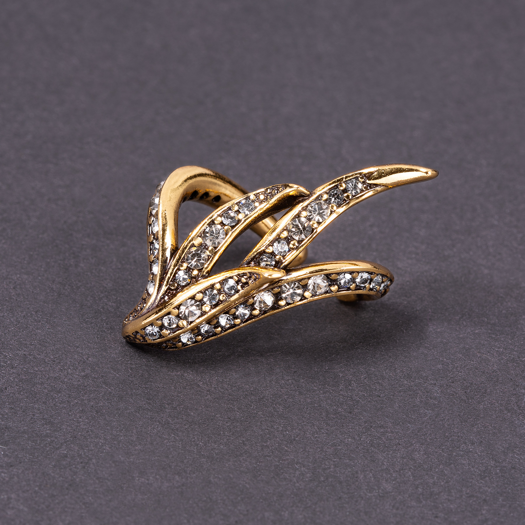 Lewa pozłacana nausznica w formie piór z kryształami. TWÓJ SHOWTIME