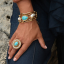 Pozłacany pierścień z błękitnym oczkiem i perełkami. KASIA