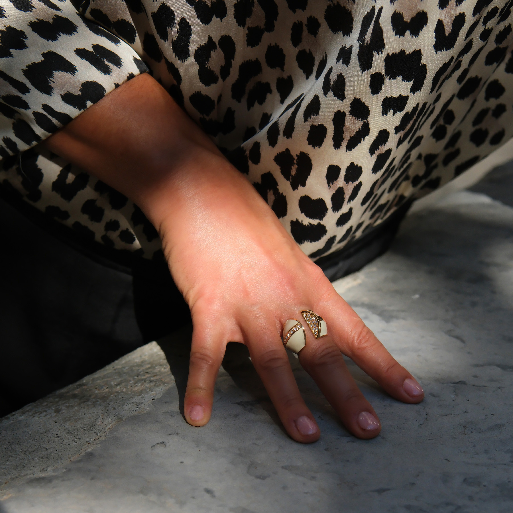 Otwarty pozłacany pierścień z białą emalią i cyrkoniami. UNO BIANCO